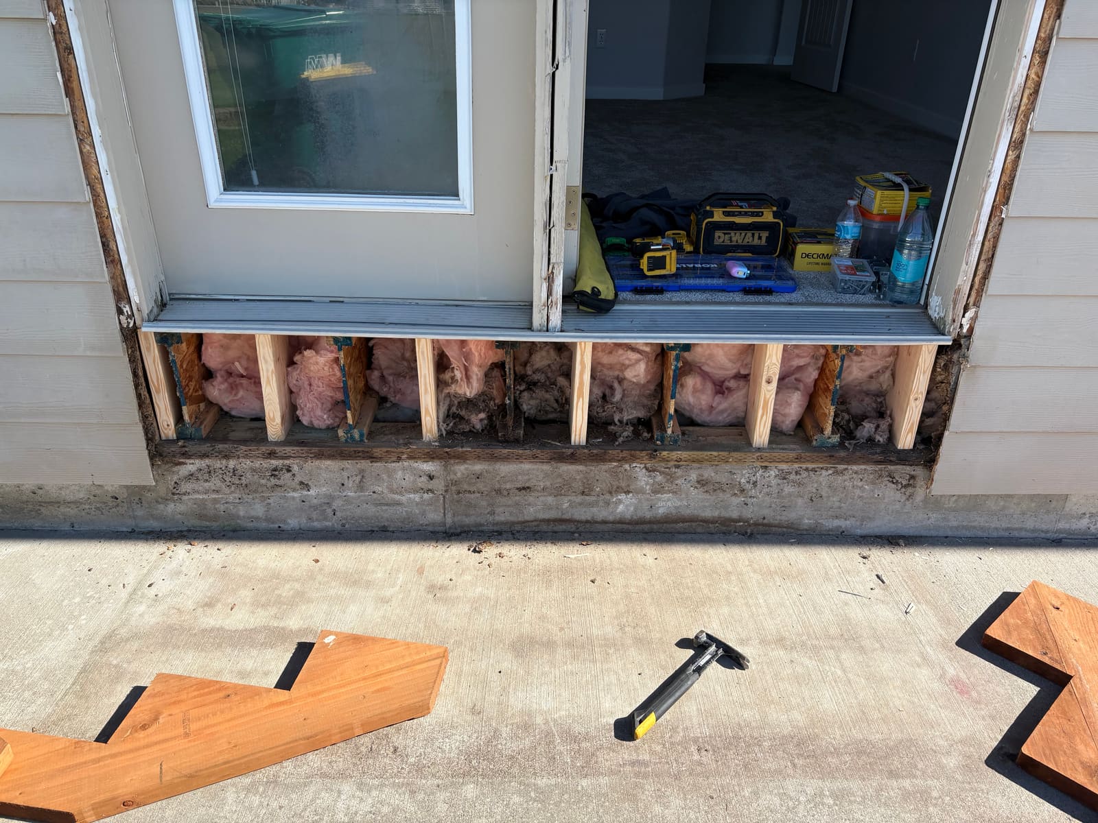 Exposed wall framing and insulation after damaged material was removed