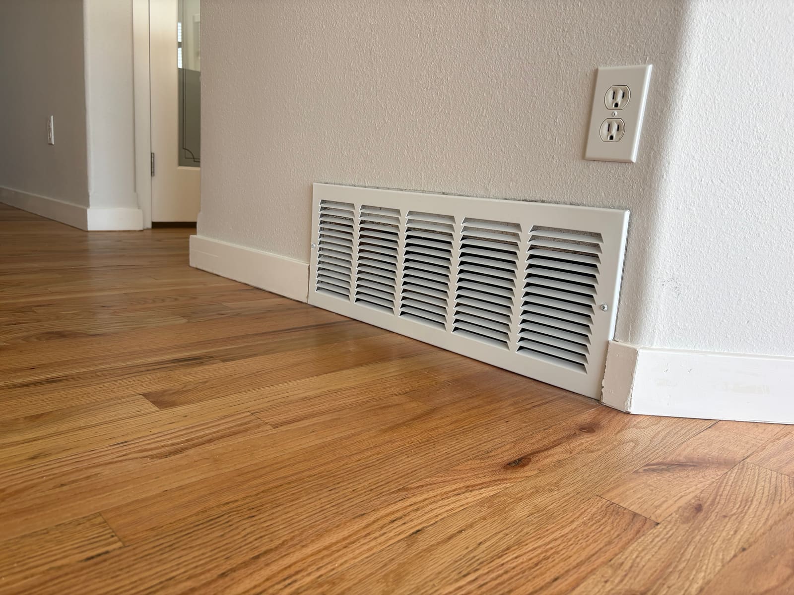 New floor vent cover installed on a hardwood floor